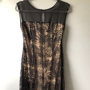 Sheer black sequined dress.